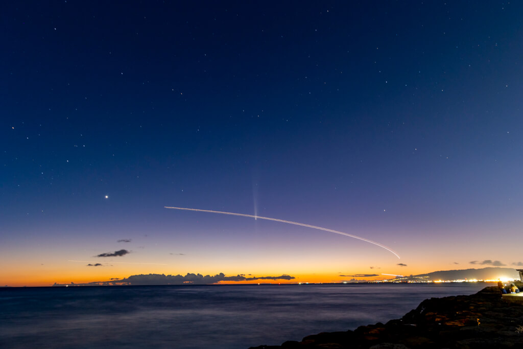 Comet Tsuchinshan-ATLAS with an airplane flying past it