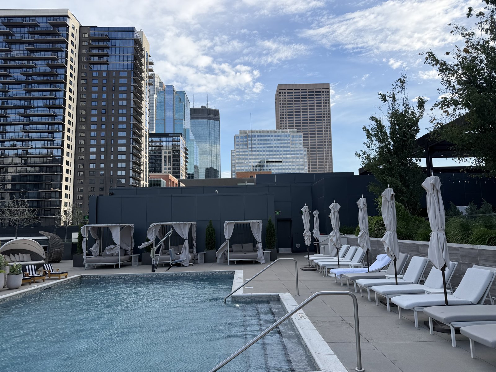 The rooftop pool and skyline at Riva Terrace