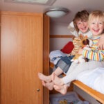 two children part of a family of five in a class c rv