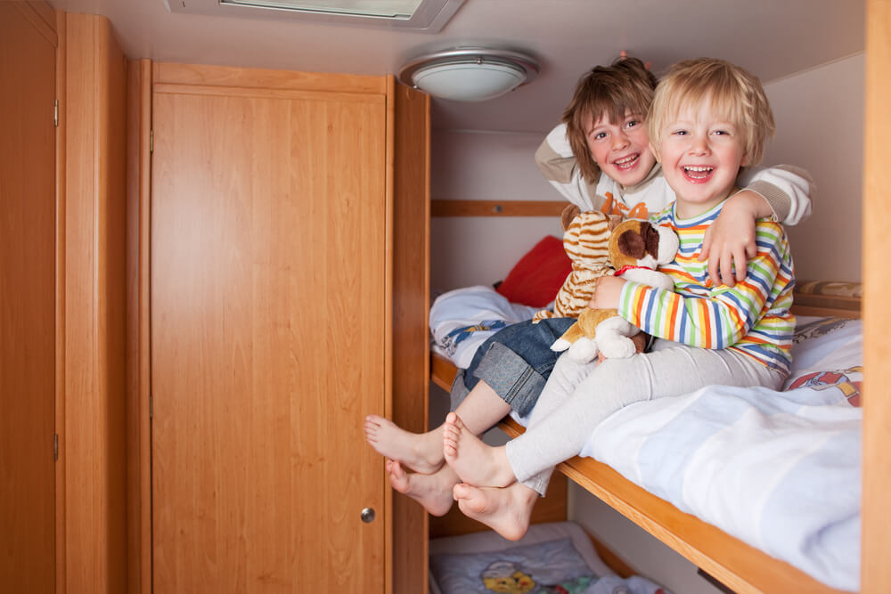 two children part of a family of five in a class c rv