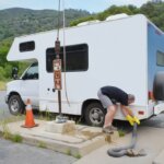 man using an RV dump station the correct way