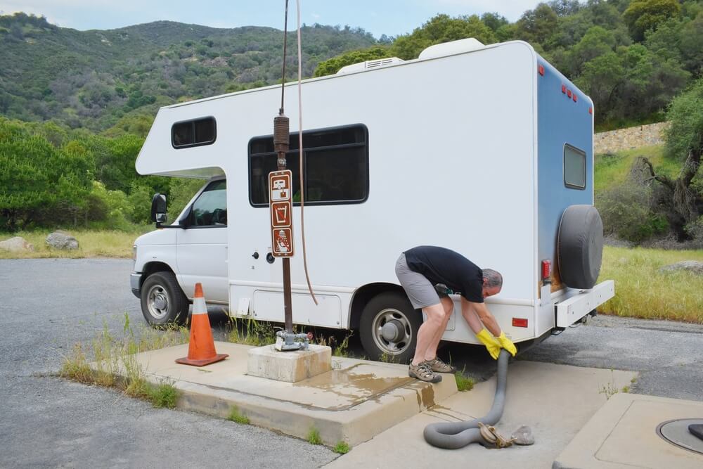 man using an RV dump station the correct way