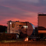 Sunset over the campground on the first night — fire glowing, RVs silhouetted, and one of the best phone photos I've ever taken