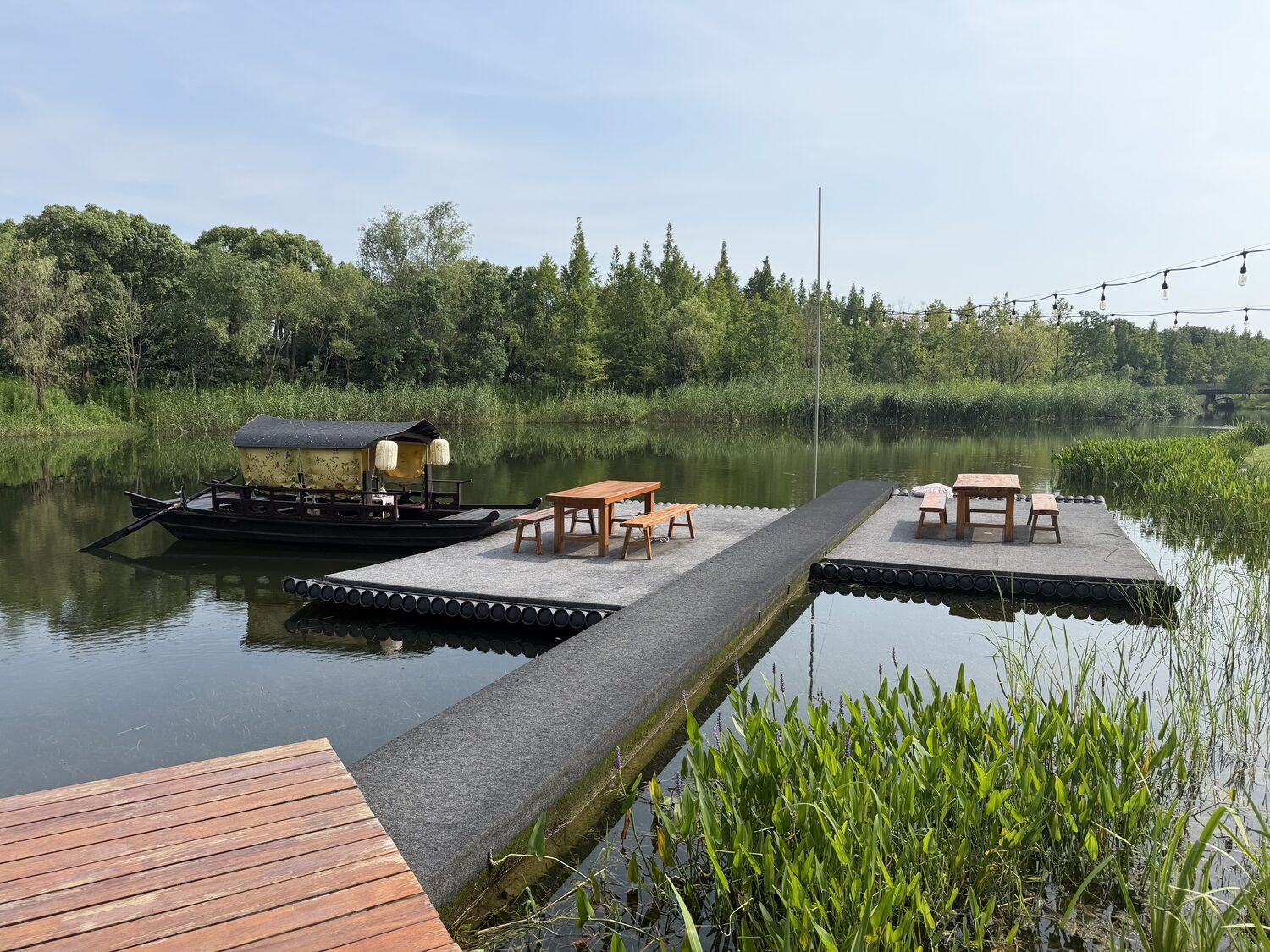 The dock. There are picnic tables out on the water.
