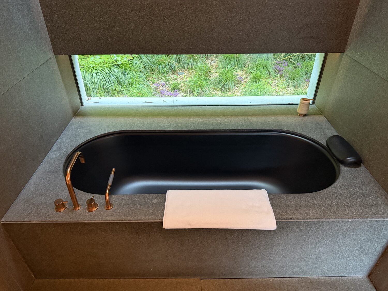 The tub has its own window into the garden.